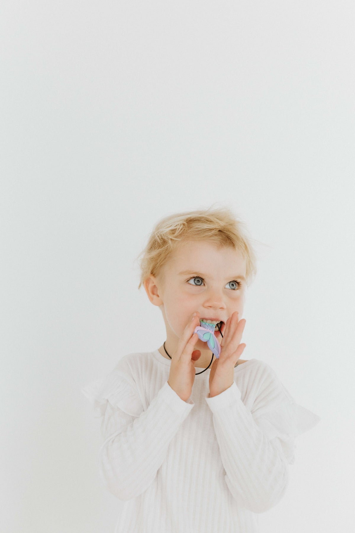 Kid Holding The Mermaid Pendant White Biting