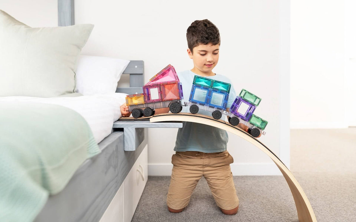 kid playing pastel transport pack in a kinderboard