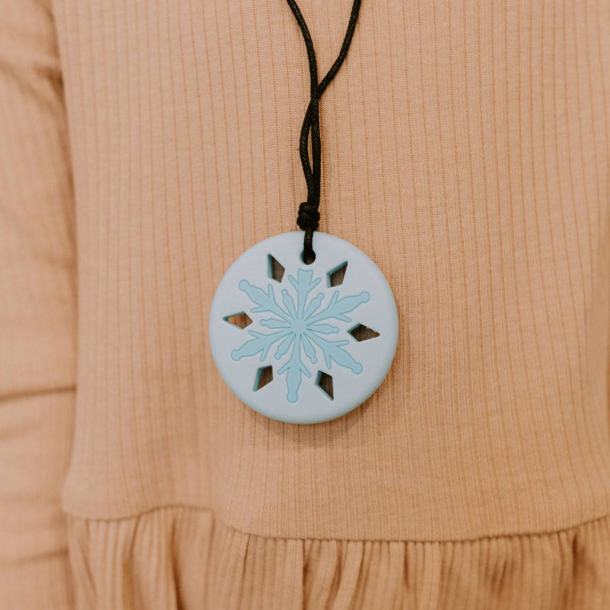 snowflake pendant lifestyle image worn by a girl