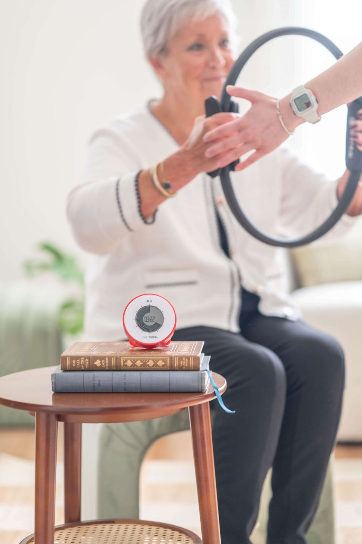 time timer twist with kickstand on top of books used during therapy